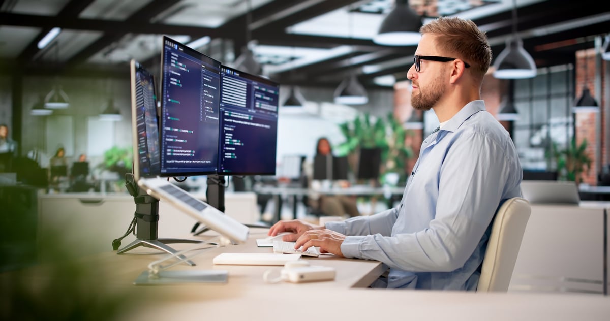 Software Developer Working On Programming Code At Office Computer Desk
